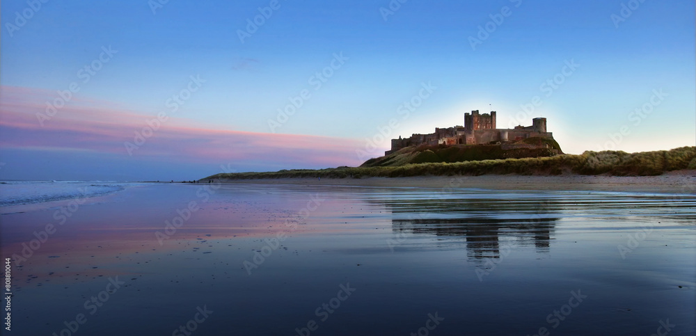 Φωτογραφία Sunset on Bamburgh Castle, on the northeast coast of England, by the village of