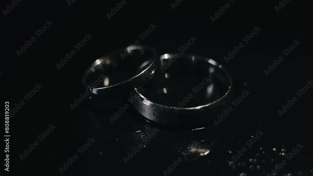 Two rings are lying on the table and they are illuminated by dynamic light casting shadows. Two rings are lying on the table and they are illuminated by dynamic light casting shadows.