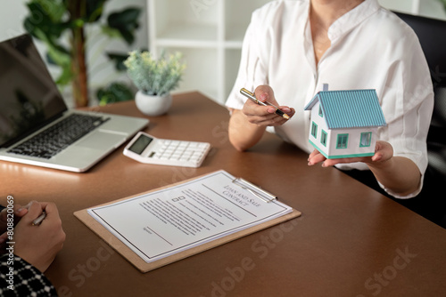 Real estate agent talking about the terms of the home purchase agreement and the customer to signing the documents to make the contract legally, Home sale and home insurance