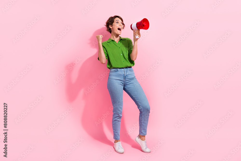Fototapeta Full size photo of pretty young girl raise fist excited celebrate loudspeaker we