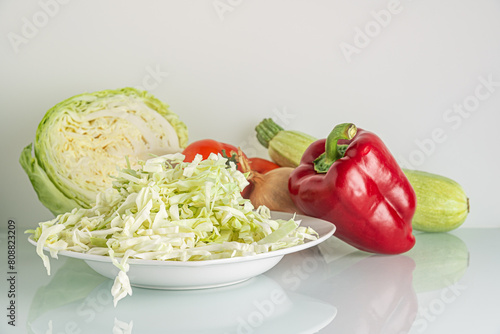 vegetables for salad or soup: tomato, cabbage, sweet pepper, zucchini and onion close up shallow depth of field