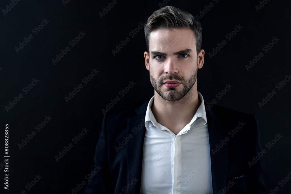 Portrait of confident businessman wearing formal costume white shirt standing isolated over black background. Business expert. Handsome young man in full suit looking at camera Portrait of confident businessman wearing formal costume white shirt standing isolated over black background. Business expert. Handsome young man in full suit looking at camera