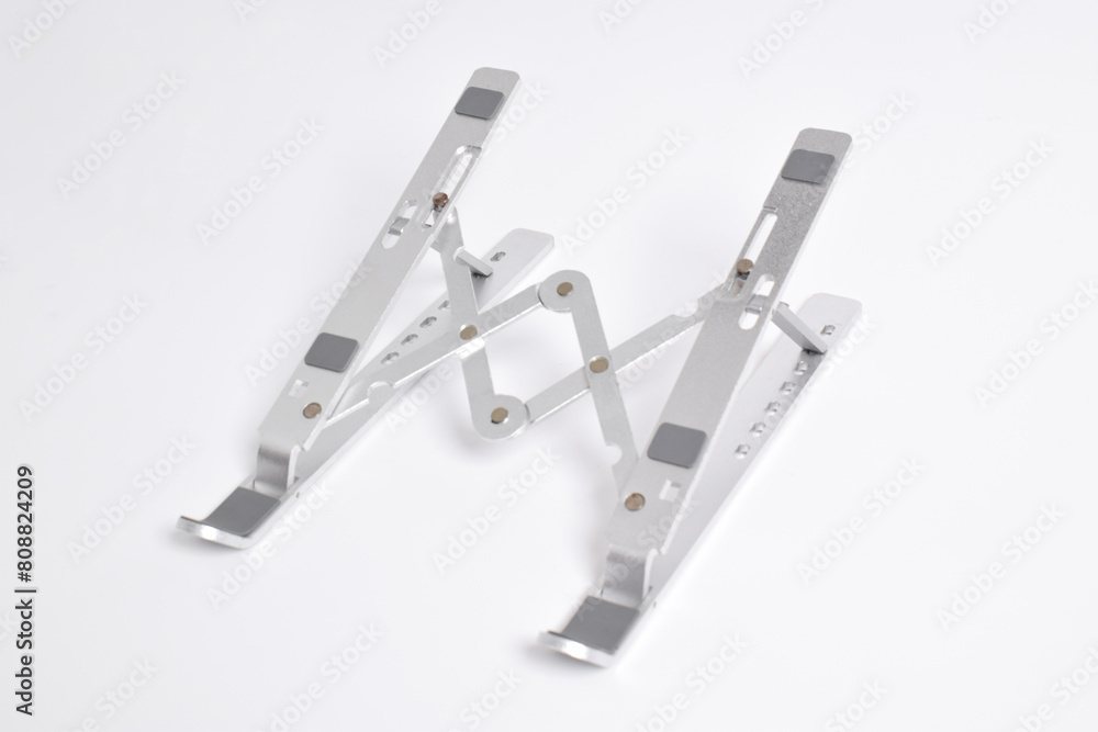 Portable metal laptop stand perspective view isolated on white background. Portable metal laptop stand perspective view isolated on white background.
