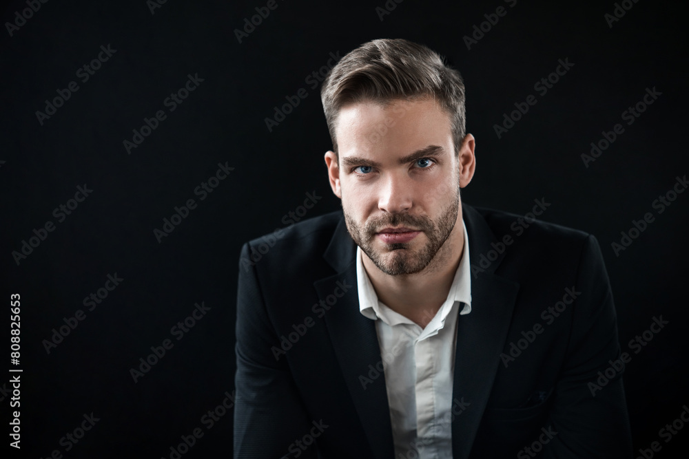 Portrait of businessman wearing formal wear suit white shirt standing isolated over black dark background. Handsome young man investor IT-worker in full suit looking at camera Portrait of businessman wearing formal wear suit white shirt standing isolated over black dark background. Handsome young man investor IT-worker in full suit looking at camera