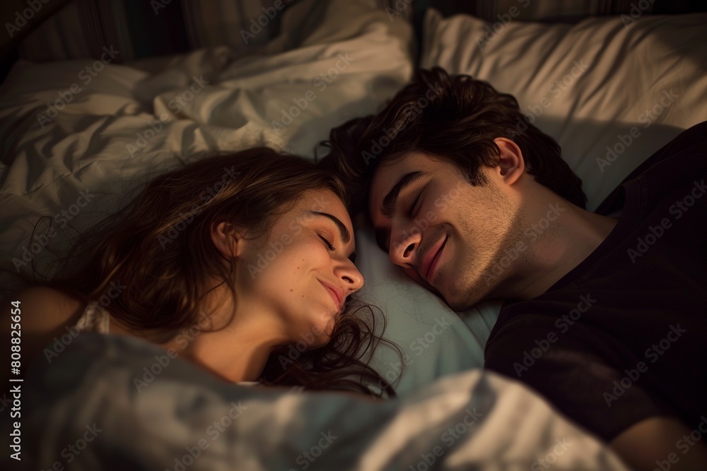 Man and Woman Laying in Bed Under a Blanket Man and Woman Laying in Bed Under a Blanket