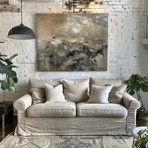 A beige sofa in front of an offwhite brick wall, with a floor lamp and potted plants adding warmth to the space. A large abstract painting hangs above it, creating a cozy living room atmosphere photo