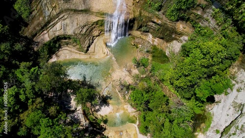 4K Aerial Drone video of epic tall waterfalls falling to rocks in canyon surrounded by jungle, Can-Umantad Falls in Bohol, Philippines photo