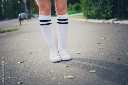 Photo portrait of lovely teen lady sneakers legs schoolgirl dressed stylish uniform garment autumn park sunny day background