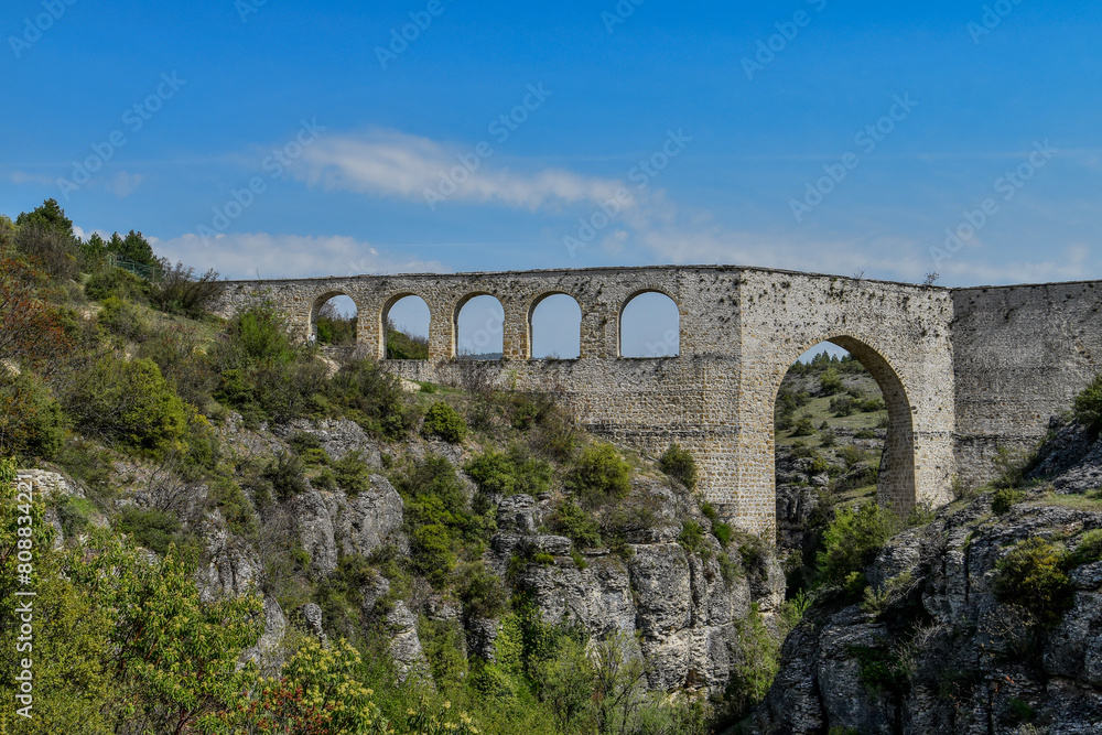 Incekaya Aqueduct, a marvel of Ottoman engineering, spans the rugged landscape with its majestic arches, serving as a testament to Turkey's rich historical legacy and mastery of water management