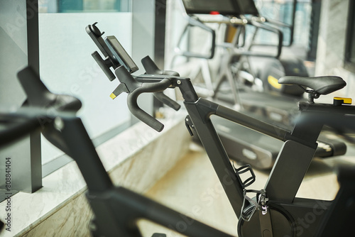 Modern Fitness Center- Bright, spacious gym with cardio machines and natural light