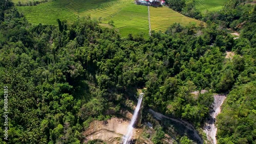 4K Aerial Drone video of epic tall waterfalls falling to rocks in canyon surrounded by jungle, Can-Umantad Falls in Bohol, Philippines photo