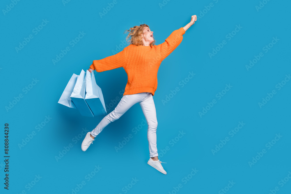 Φωτογραφία Photo of crazy funny lovely woman wear trendy orange clothes hold packages fly e