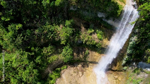 4K Aerial Drone video of epic tall waterfalls falling to rocks in canyon surrounded by jungle, Can-Umantad Falls in Bohol, Philippines photo