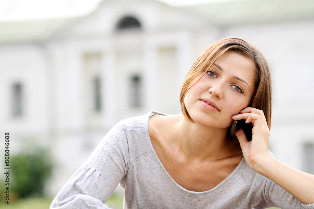 Young happy woman calling by phone on the street Young happy woman calling by phone on the street