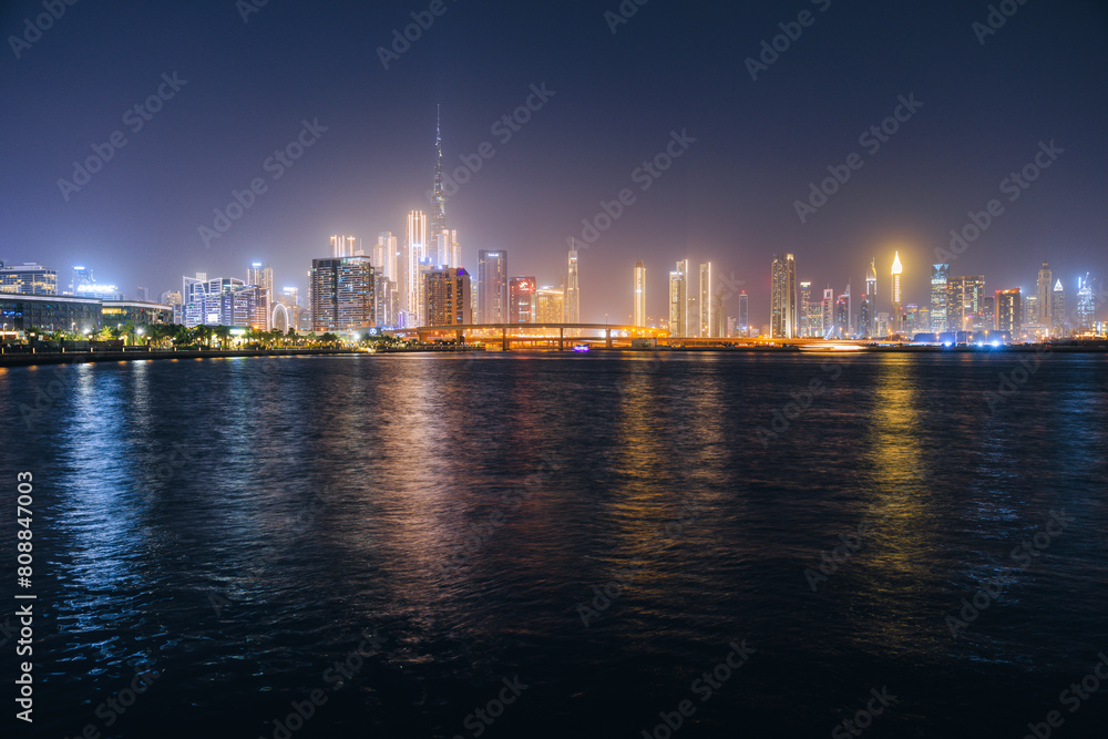 Night view of Dubai city skyline from Dubai Design District walking path