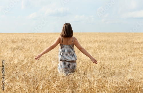Happy woman in golden wheat © Andrey_Arkusha