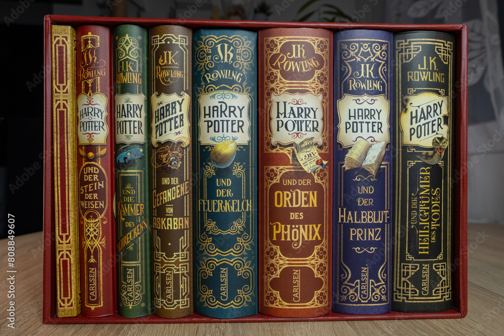 Fototapeta premium complete colorful collection paper books by JK Rowling about Harry Potter, appealing to book lovers, especially fans children's literature and fantasy, Frankfurt - December 22, 2023