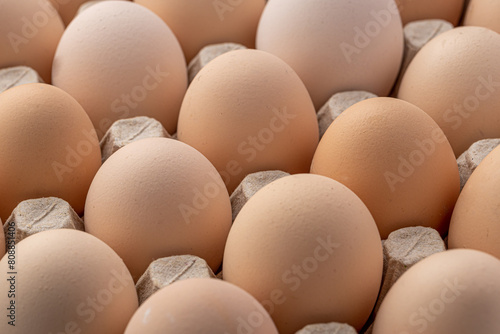 Brown eggs stacked in rows.Group of Fresh white Eggs in a cardboard cassette. Organic food from nature good for health.