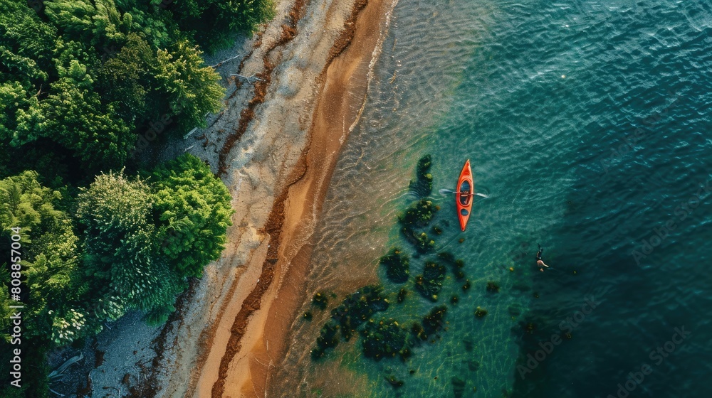 A serene aerial view of a wooden kayak floating in the clear waters near a sandy beach, with lush green trees creating a beautiful natural landscape AIG50