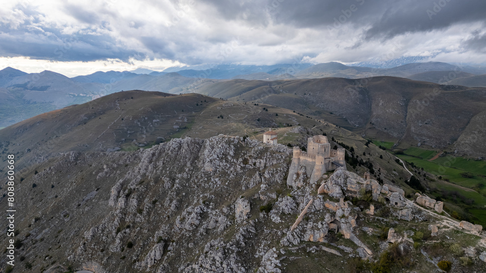 Fototapeta premium Rocca Calascio at sunset with cold light and threatening clouds