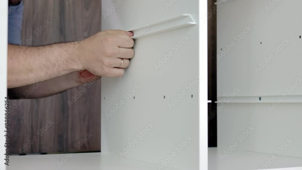 Installation of a drawer on guides in a cabinet. Furniture assembler by handyman Installation of a drawer on guides in a cabinet. Furniture assembler by handyman