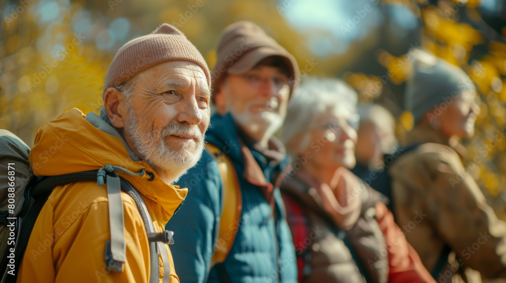 Group of senior people wearing backpacks standing together, enjoying nature walk outdoor activities