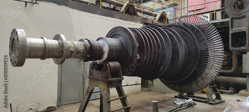 Disassembled steam turbine in the process of repairing and electric generator at power plant