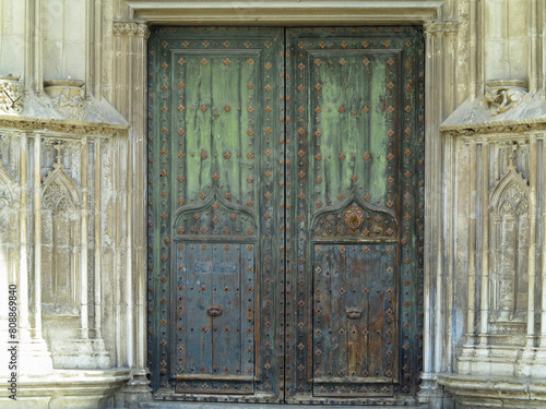 An ancient weathered stylish old wooden door