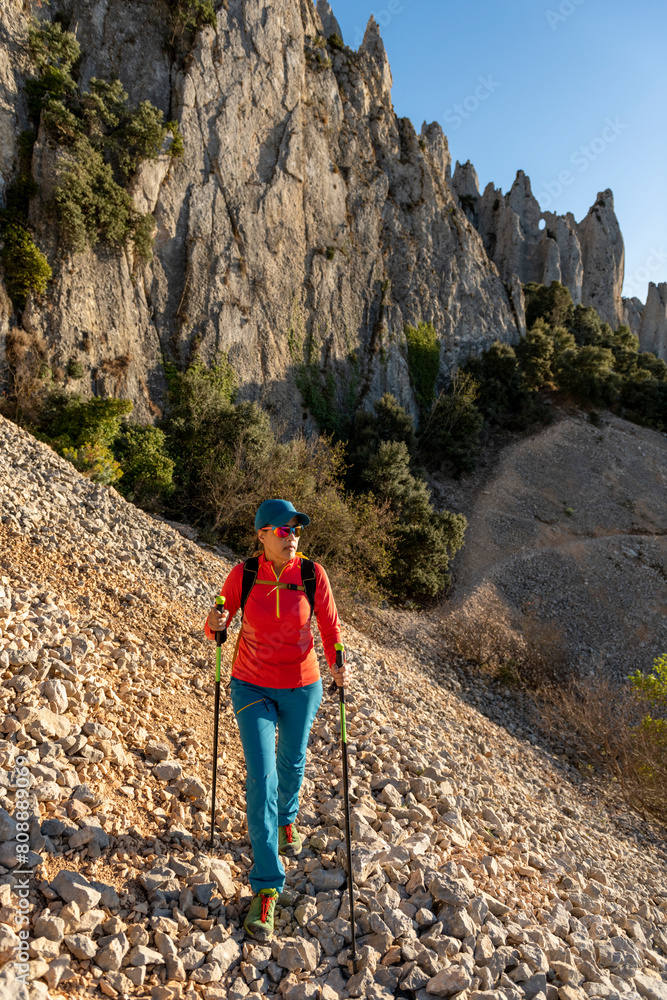 Woman backpacker on the hiking path to Frares de Serrella mountain range on Costa Blanca, Quatretondeta , Alicante, Spain - stock photo Woman backpacker on the hiking path to Frares de Serrella mountain range on Costa Blanca, Quatretondeta , Alicante, Spain - stock photo