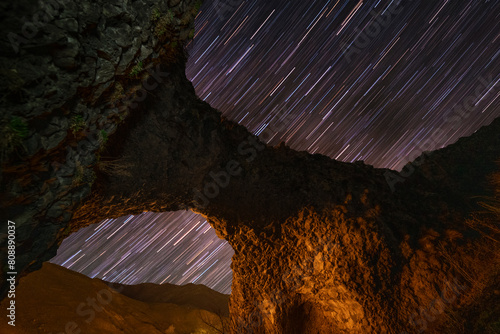 Star trails  over the stone arch. Night landscape.  © Inga Av