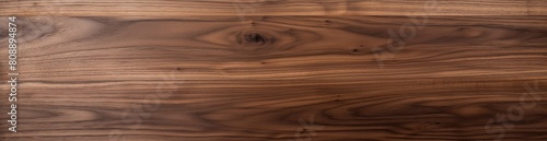 High-resolution image capturing the intricate details of a smooth walnut wood grain  perfect for a natural and elegant backdrop in design projects or as a texture overlay