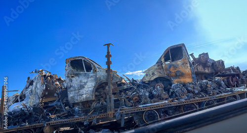 burnt-out car transporter with cars on a trailer, risks and an insured event for transporting cars.