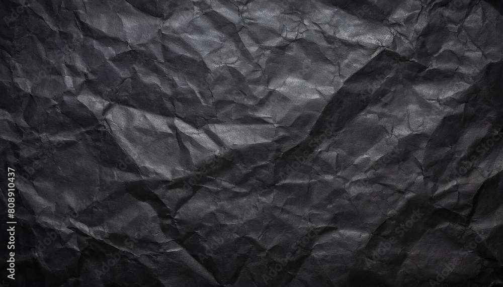 Black crumpled paper texture in low light background Black crumpled paper texture in low light background