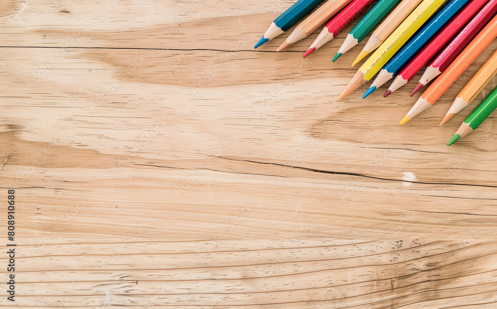 photo of a light-colored desk seen from above, with scattered colored pencils on it photo of a light-colored desk seen from above, with scattered colored pencils on it