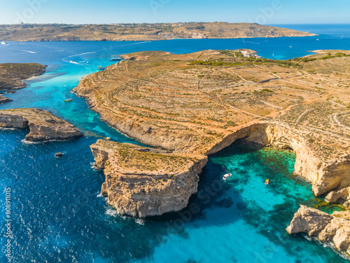 Aerial drone view of Crystal lagoon on Comino island. Boats. Mediterranean sea, Malta