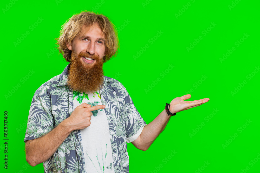 Φωτογραφία Young bearded man showing thumbs up and pointing right empty place, advertising area for commercial text copy space for goods promotion advertisement
