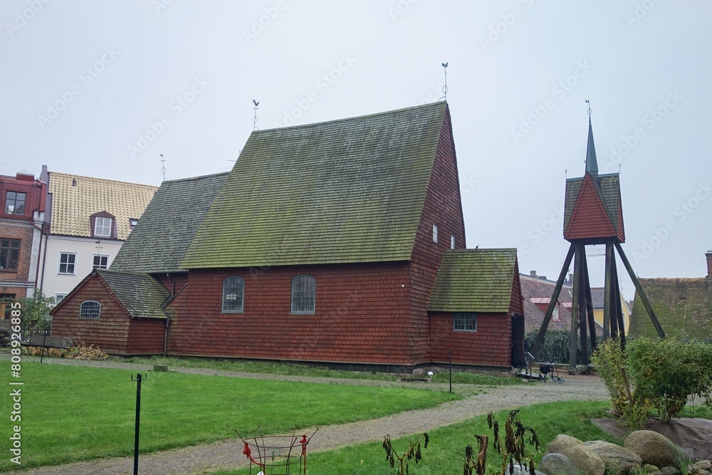 Fototapeta premium Ancient Bosebo kyrka red wooden church in culture museum in Lund, Sweden in autumn weather