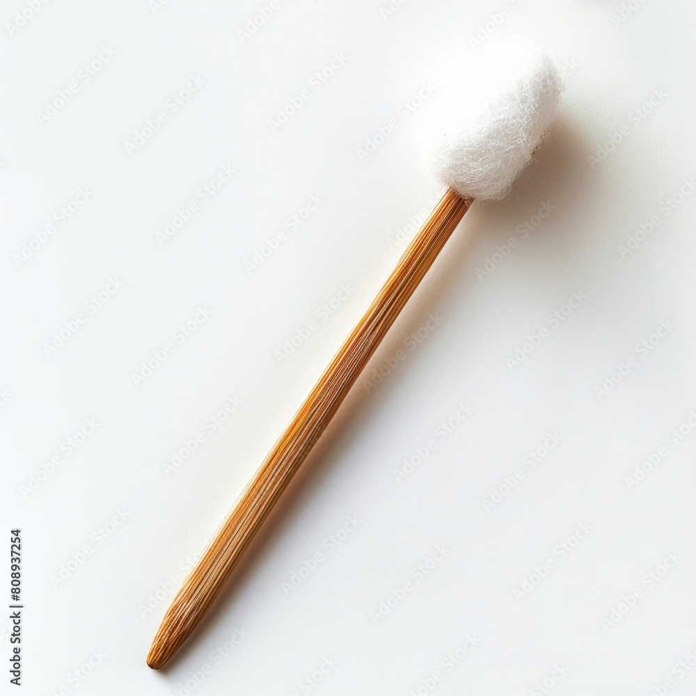 a wooden stick with a cotton ball on it a wooden stick with a cotton ball on it