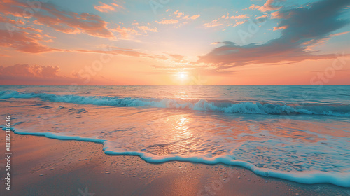 Sunrise over Ocean Waves with Pink and Orange Sky Reflecting on Sandy Beach