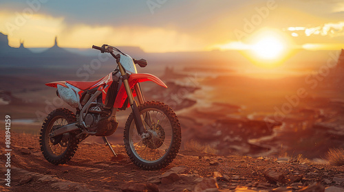 Red Dirt Bike Parked on Rocky Mountain at Sunset with Desert Vista View