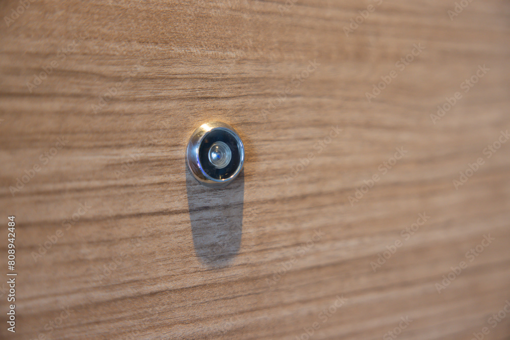 door lens peephole on wooden background and texture. eyehole on front door. door lens peephole on wooden background and texture. eyehole on front door.