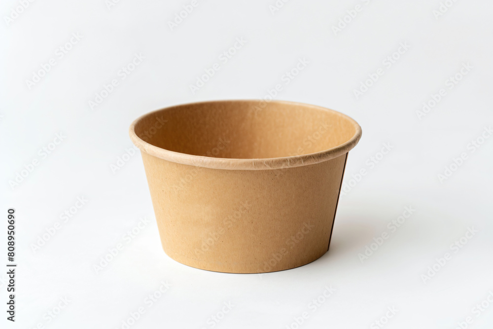 a brown paper cup sitting on top of a white surface a brown paper cup sitting on top of a white surface