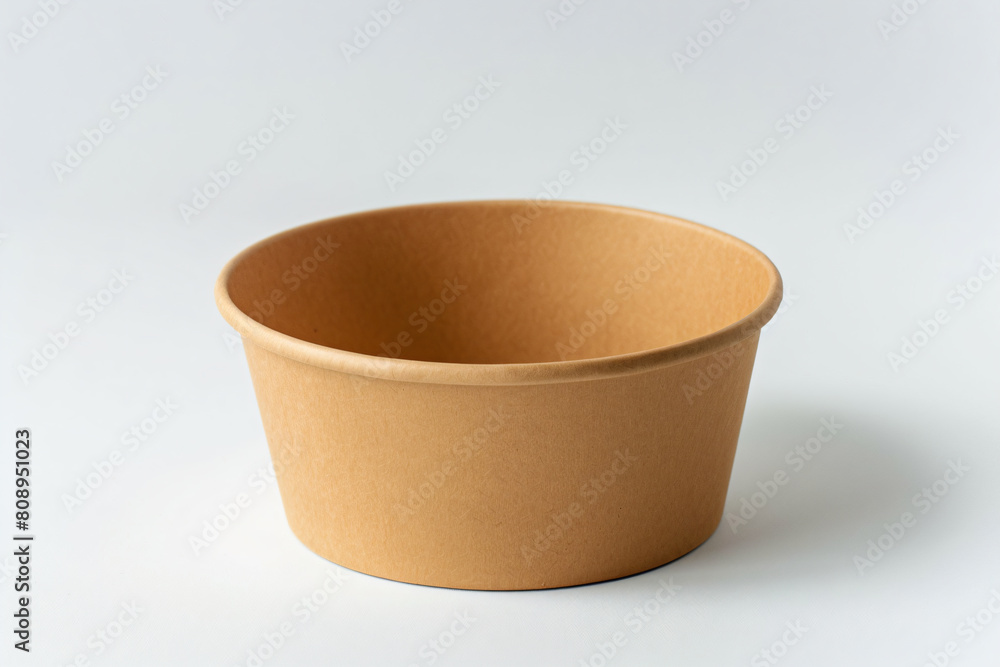 a brown paper cup sitting on a white surface a brown paper cup sitting on a white surface