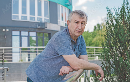 Mature European man with a good mood, outdoor portrait. The concept of life after 50 years	