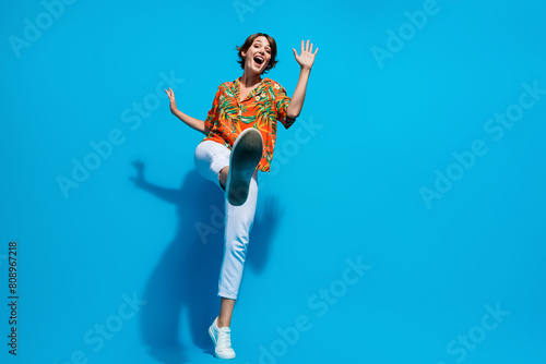 Full body photo of astonished overjoyed lady dancing empty space ad isolated on blue color background