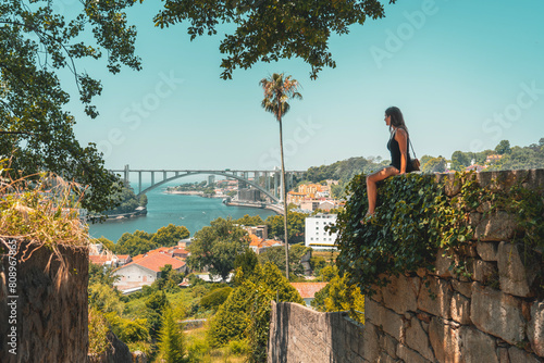 tourist woman enjoying the view over Porto Portugal from the Jardins do Palacio de Cristal Crystal Palace gardens photo