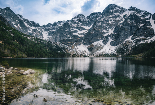 Fototapeta Naklejka Na Ścianę i Meble -  A mountain lake surrounded by trees and rocks
