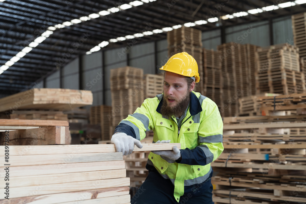 Male worker working in wooden warehouse storage. Male construction worker working at wooden warehouse Male worker working in wooden warehouse storage. Male construction worker working at wooden warehouse