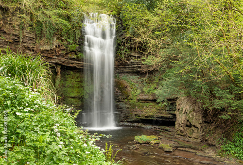 Beautiful waterfall cascading and dropping into a pool