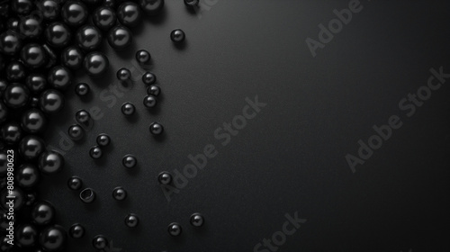 Close-up view of black pearl-like spheres on a matte surface. Minimal background with empty copy space for design. Generative AI